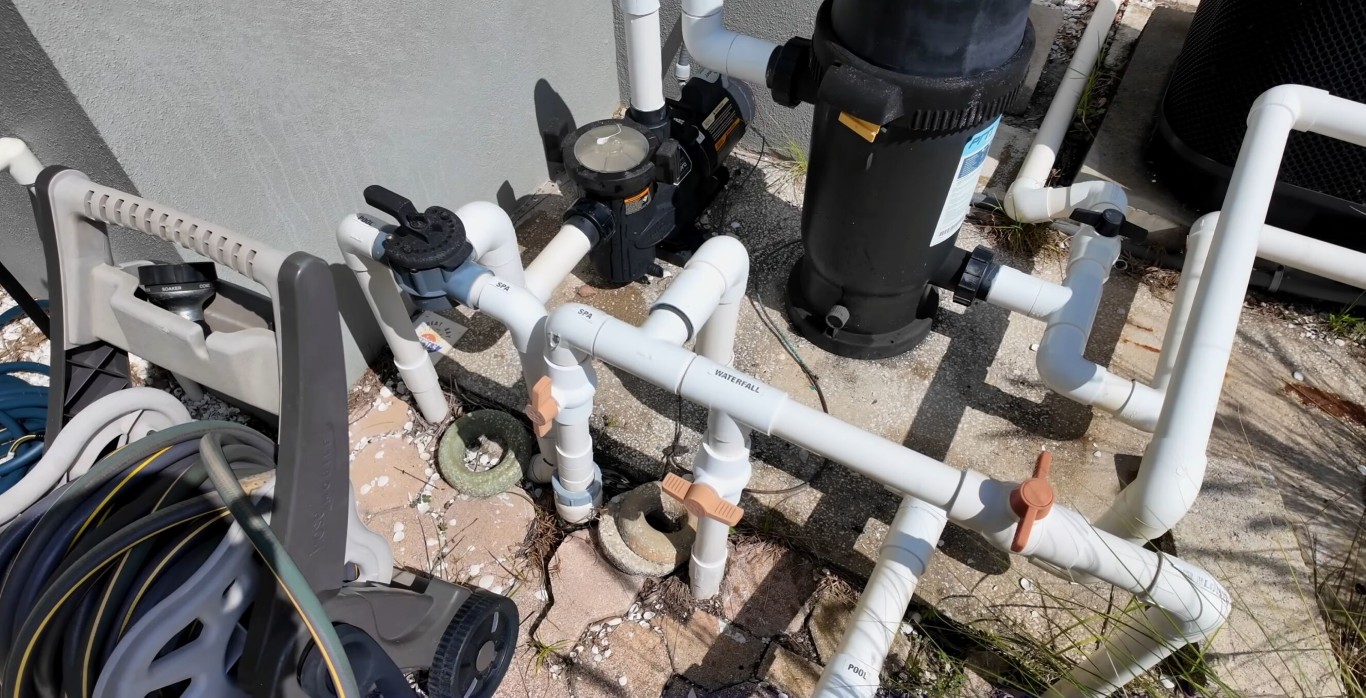 Pool filtration system with clean white PVC piping and pump equipment in Leesburg, FL