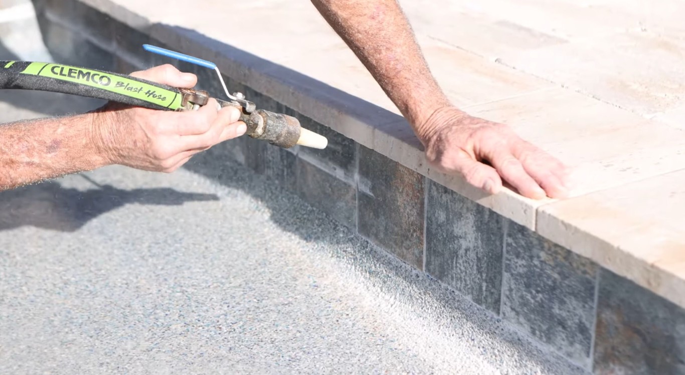 Professional technician cleaning pool tile with specialized equipment to remove calcium buildup in Leesburg, FL